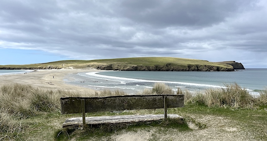 Scenic wooden bench overlooking St Ninian's, Shetland